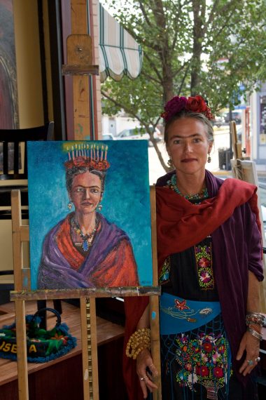 Colleen Webster as Frida Kahlo next to Kahlo self portrait